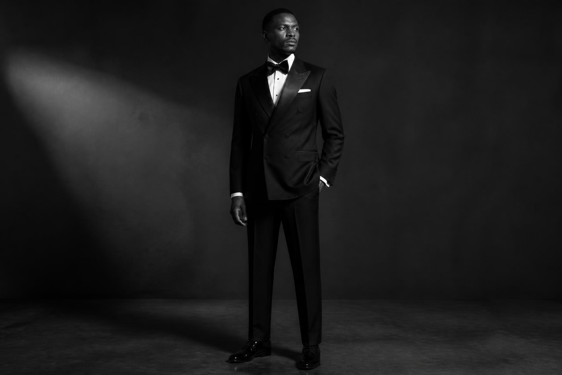 Model wearing a tailored black tuxedo